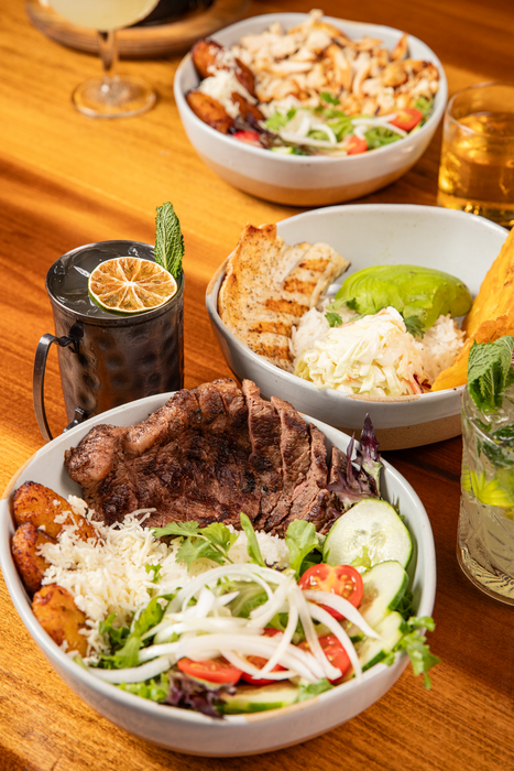 Image of three plates of food with two glasses of drink.