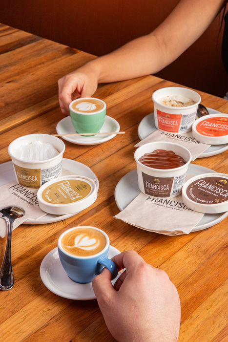 Image of two people eating desserts and drinking coffee